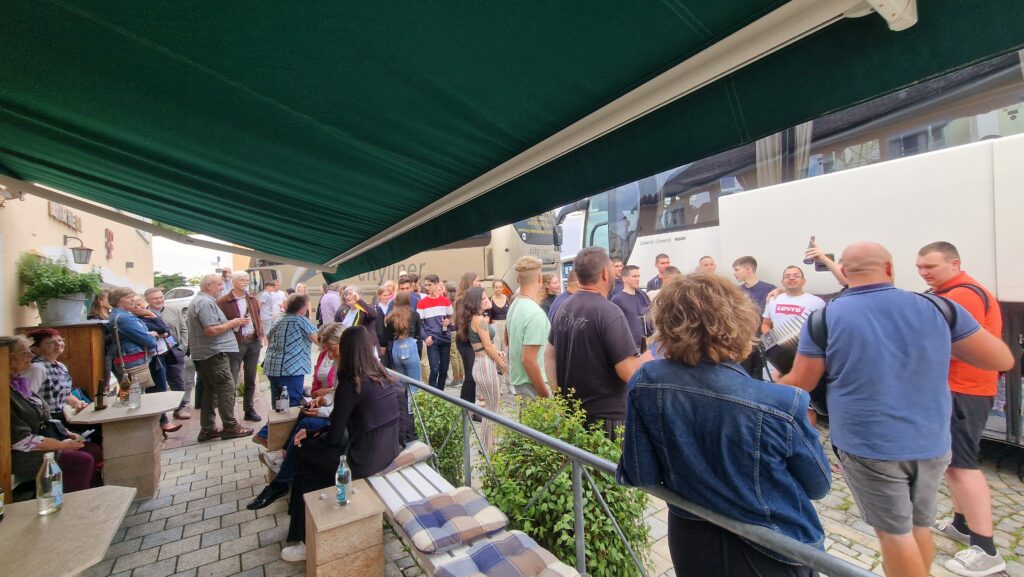 Eine Menschenmenge wartet auf ein Busfahrt auf dem Marktplatz Altomünster.